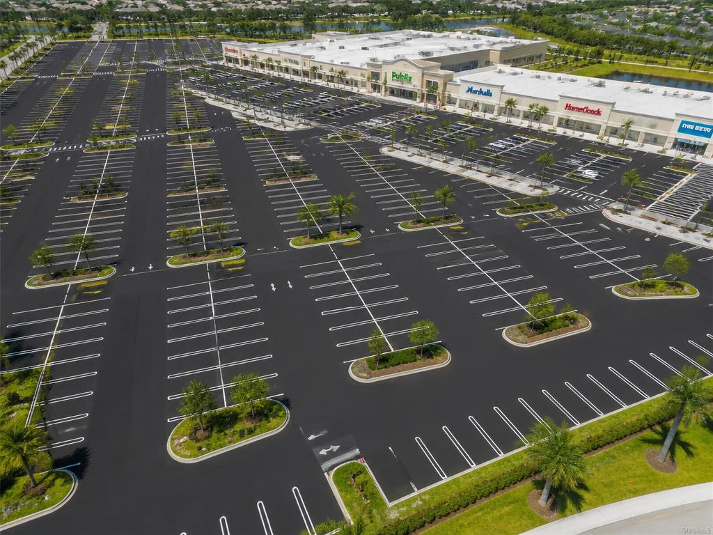 Aerial view of a large freshly sealed and striped shopping center lot